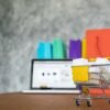 laptop, shopping trolley and shopping bag